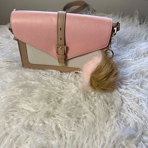 Lady’s handbag with fur ball keychain